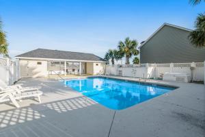a swimming pool in front of a house at Paradise in the Palms in Mexico Beach