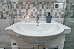a bathroom sink with a candle on top of it at Domek drewniany luxury cottage Dabrowa in Zakopane +27 photos