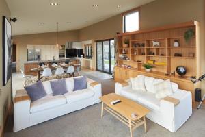 a living room with two white couches and a table at Takapō Retreat - Lake Tekapo in Lake Tekapo