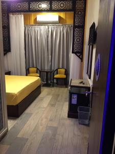 Ένα ή περισσότερα κρεβάτια σε δωμάτιο στο The location Hotel