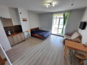 an empty living room with a bed and a table at K&K Apartments Gulliver 468 in Perm