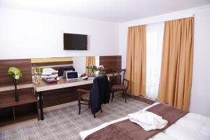 TV a/nebo společenská místnost v ubytování Primus Hotel & Apartments