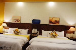 Ένα ή περισσότερα κρεβάτια σε δωμάτιο στο The location Hotel