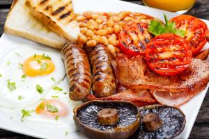 a plate of breakfast food with eggs sausage beans and toast at Lyndhurst Hotel in Blackpool