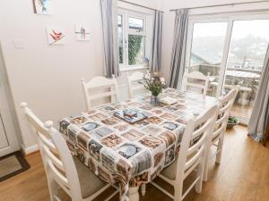 a dining room with a table and chairs and a window at Avondale in Porthmadog