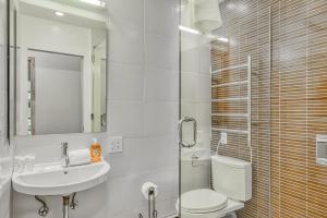 a bathroom with a sink and a toilet and a mirror at The Lazy Golden Cabin in South Lake Tahoe +32 photos
