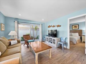 a living room with a couch and a tv at Newly Fully Updated and Modern, Short Walk to BEACH in Siesta Key