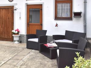 a patio with chairs and a table and a door at Holiday home in Elbingerode with garden in Rübeland