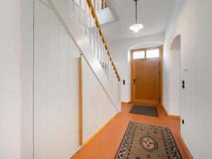 a hallway with a staircase and a rug on the floor at Holiday home in the Upper Palatinate Forest in Neunburg vorm Wald