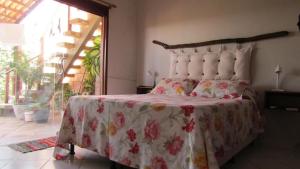 a bedroom with a bed with a red and white blanket at Brisas do Amor 131 in Pipa +38 photos