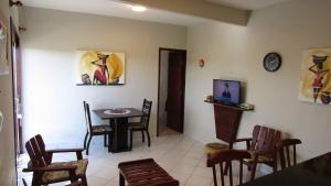 a living room with a dining room table and chairs at Brisas do Amor 131 in Pipa