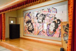 a large painting on a wall in a room at Yanagi No Yu in Aomori
