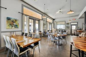 a dining room with wooden tables and chairs at Hotel Whiskey in Pass Christian in Pass Christian