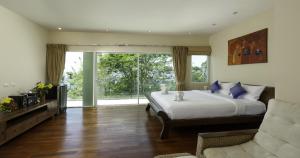 a bedroom with a bed and a large window at Villa Yoosook in Patong Beach +55 photos