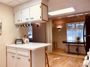 a kitchen with white cabinets and a counter top at Red Lodge Town Cottage in Red Lodge