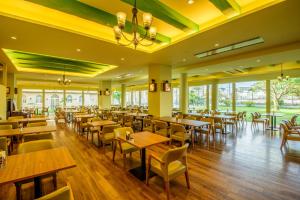 a restaurant with tables and chairs and windows at Pacific Hotel Okinawa in Naha +105 photos