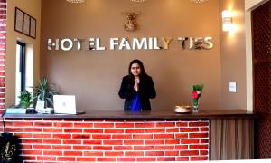 a woman standing at a reception desk at Hotel Family Ties Pvt. Ltd. in Kathmandu