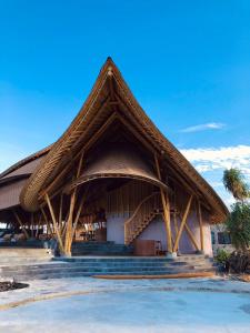a large building with a thatched roof at Tanoma Sumba in Maujawa +75 photos