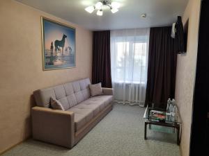 a living room with a couch and a table at Arirang Hotel in Khabarovsk