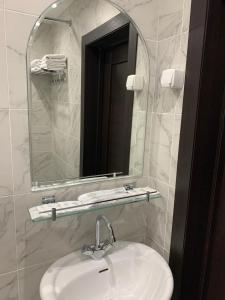 a bathroom with a sink and a mirror at Arirang Hotel in Khabarovsk