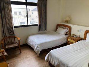 Postel nebo postele na pokoji v ubytování 金麗麗大飯店