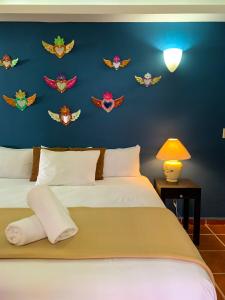 a bedroom with two beds and a blue wall with fish decals at La Iguana Vallarta LGBT - Romantic Zone - Party Clubbing Street in Puerto Vallarta