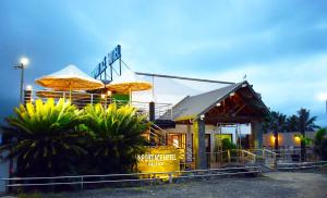 a fast food restaurant with umbrellas in front of it at Airport Ace Hotel in Nadi