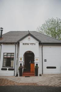 a white building with the entrance to aiger viettex at Lydenburg Manor Guest House in Lydenburg