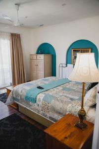 A bed or beds in a room at Lydenburg Manor Guest House