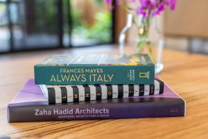 dos libros apilados uno encima del otro en una mesa en Azure at Funnel Bay, en Airlie Beach