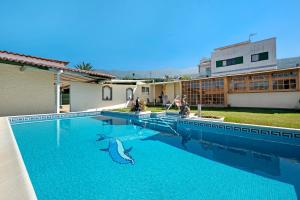 a swimming pool with two dolphins in the water at V Vacacional con encanto la Orotava in La Orotava