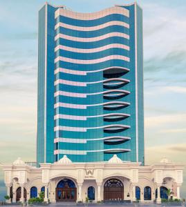 a large building with a large blue tower at WA Hotel in Jeddah
