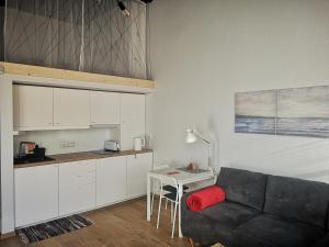 a living room with a couch and a table at Botanical Garden Studio in Kaunas