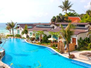 a swimming pool in front of a resort at The Samui Beach Resort in Koh Samui