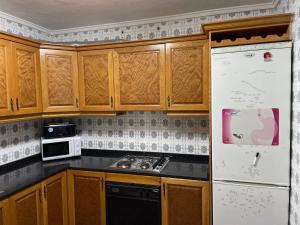A kitchen or kitchenette at APARTAMENTO TURISTICO MILLAN
