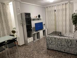 A television and/or entertainment centre at APARTAMENTO TURISTICO MILLAN