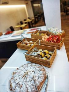 
a table topped with lots of different types of pastries at Hotel Abelay in Palma de Mallorca
