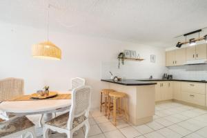 a kitchen and dining room with a table and chairs at Wintersview 9 - Lennox Head in Lennox Head