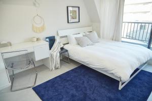 a bedroom with a large white bed and a desk at Asakusa New City Hotel in Tokyo