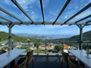 a view from a restaurant with tables and chairs at Listening to the wind B&B in Jiufen