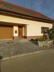 a house with a garage and a driveway at Ubytování v soukromí in Němčičky