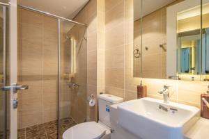 a bathroom with a toilet and a sink and a shower at 22Housing Vinhomes D'Capitale Hotel & Residence in Hanoi