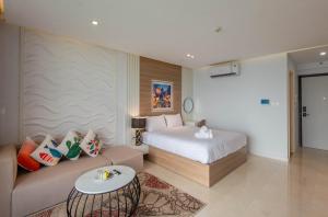 a hotel room with a bed and a couch at 22Housing Vinhomes D'Capitale Hotel & Residence in Hanoi