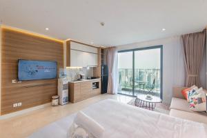 a hotel room with a large bed and a television at 22Housing Vinhomes D'Capitale Hotel & Residence in Hanoi