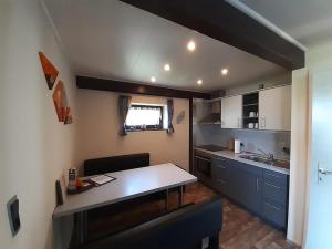 a small kitchen with a table in a room at Ferienhaus Bayerwald am Erlauzwieseler See in Waldkirchen