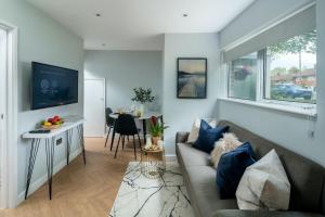 a living room with a couch and a table at Skyline Serviced Apartments - Flat A Rockingham Way in Stevenage