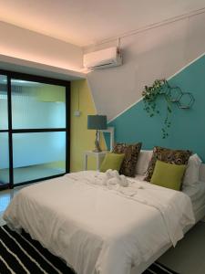 a bedroom with a large white bed with a window at MyBed Homestay in Padang Besar