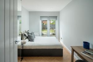 a bedroom with a bed and a desk at Skyline Serviced Apartments - Flat A Rockingham Way in Stevenage