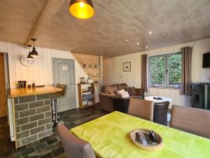 a living room with a table and a couch at Chalet Cato in Durbuy