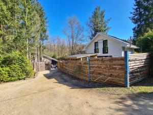 a house with a wooden fence in front of it at Chalet Cato in Durbuy